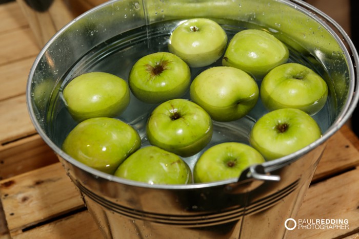 Bobbing for apples at Lark Distillery stand at Insurance Advisernet Australia Conference 2015 - Trade Show at Princes Wharf No 1 Shed. Photography by Paul Redding, Hobart Trade Show Photographer.